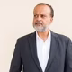 portrait-handsome-indian-man-with-gray-beard-against-plain-wall
